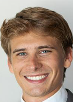 headshot of Elijah Lawrence smiling at camera in front of white backdrop