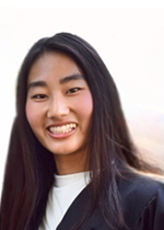 Headshot of Diane Zhang smiling wearing black blazer over white shirt in front of white background