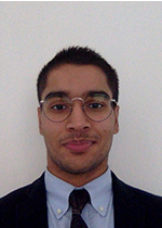 Headshot of Danyal Raza with close mouthed smile at camera, in front of white wall, wearing thin-rimmed glasses, blue shirt, black tie and black suit